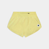 Yellow shorts with a small logo on a light gray background