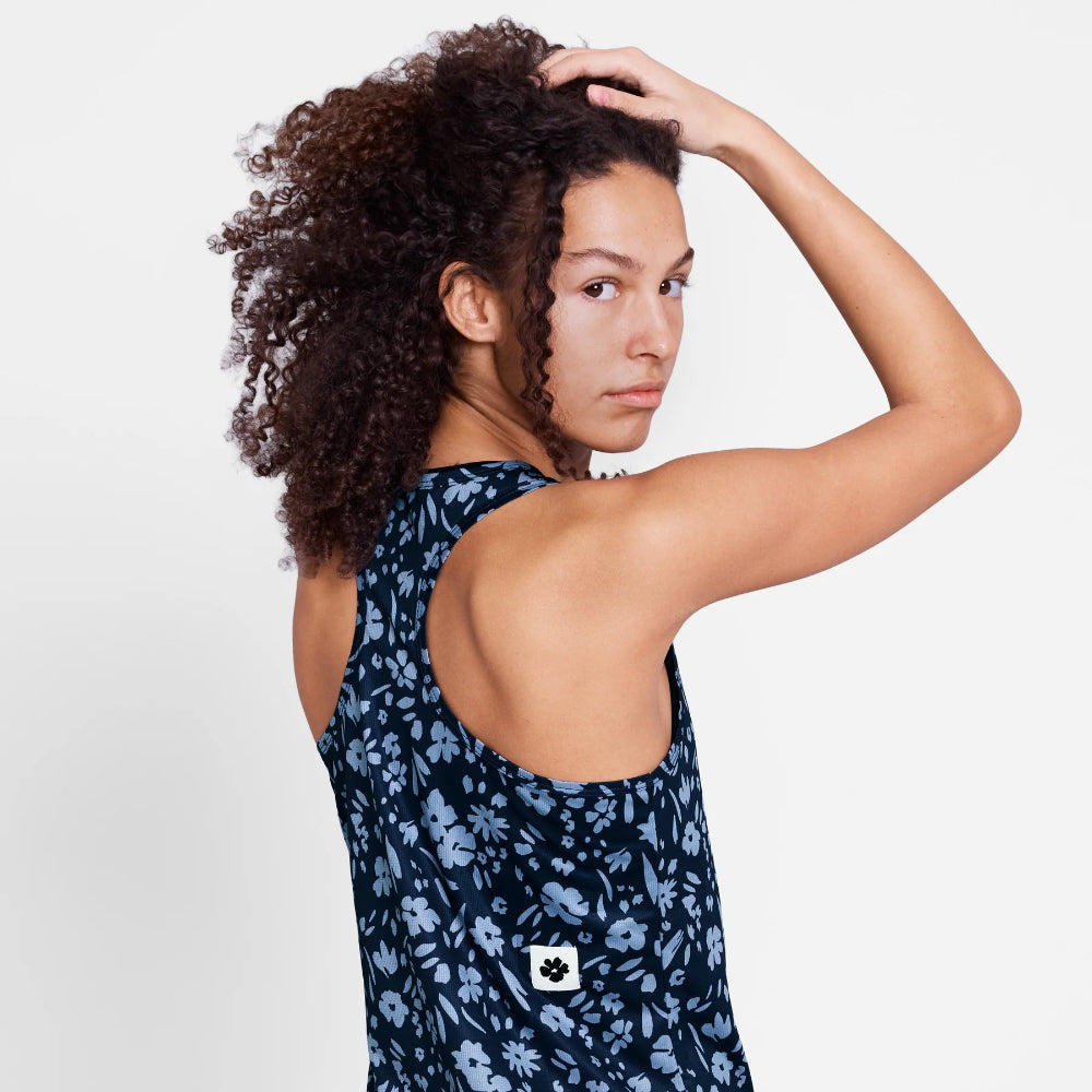 Woman wearing a navy floral dress with a white background