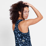 Woman wearing a navy floral dress with a white background