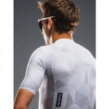 Person wearing a white cycling jersey with geometric pattern and 'Fusion' logo on a gray background
