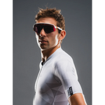 Man wearing a white cycling jersey with a dark background