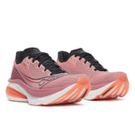 Pink running shoes with black and orange accents on a white background