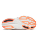 Close-up of a running shoe sole with orange and white design on a white background