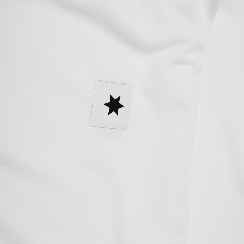White shirt with a black star patch on a white background