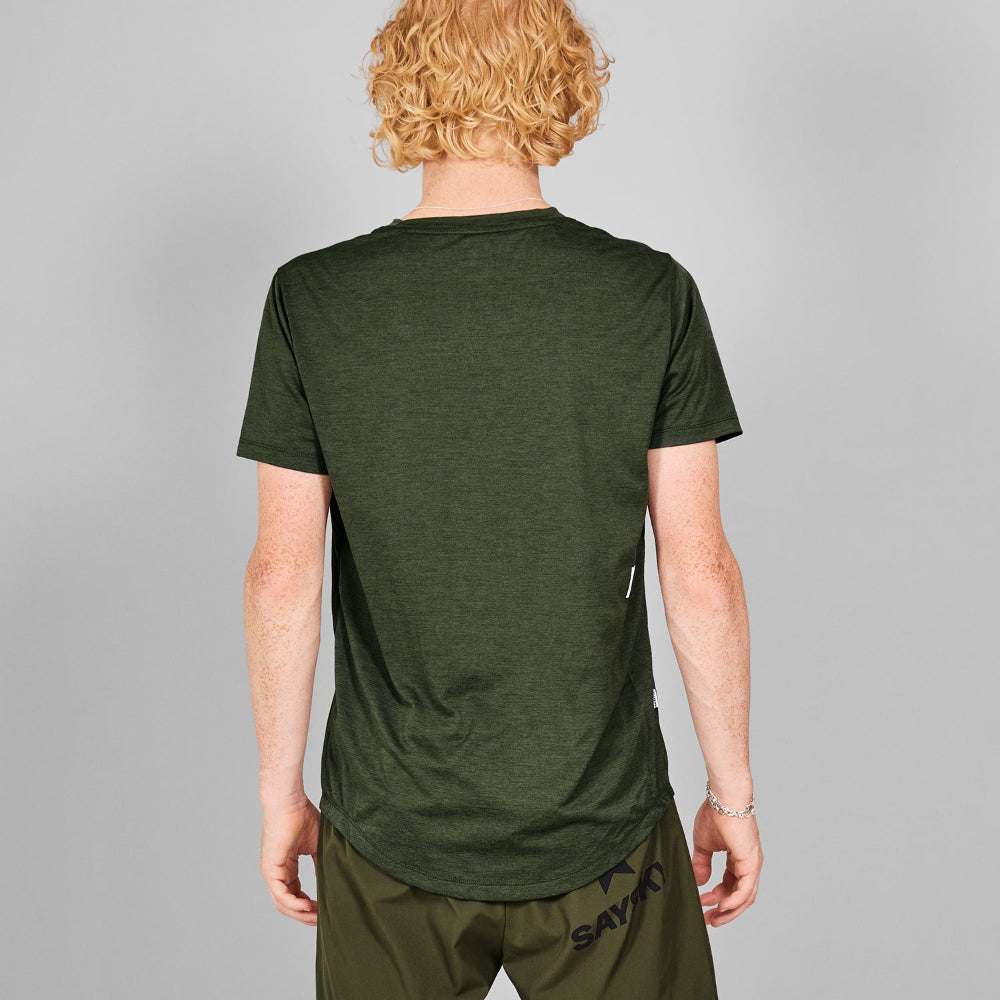 Person wearing a green t-shirt and shorts on a gray background
