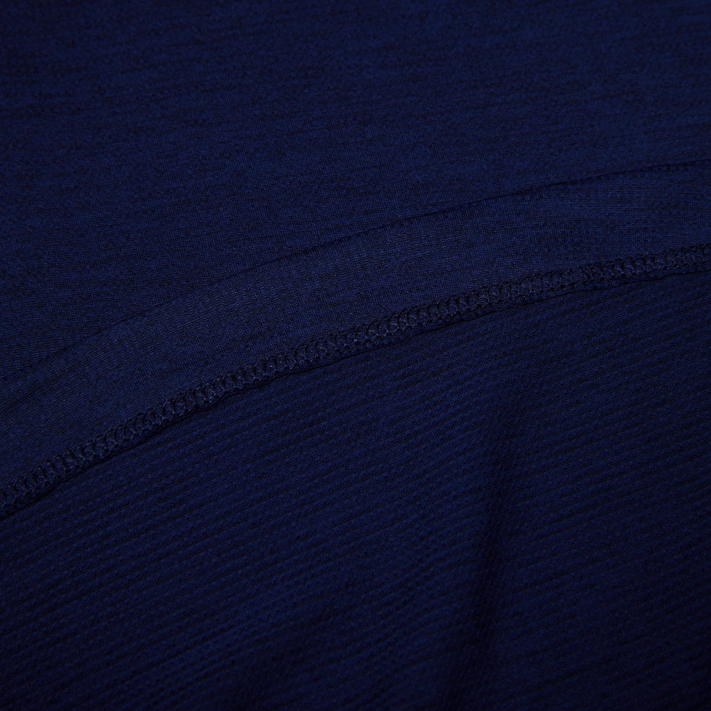 Close-up of dark blue fabric with a visible seam