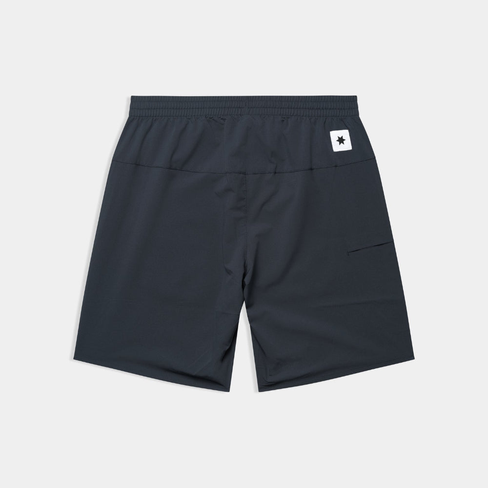 Black shorts with a small white logo on a light gray background