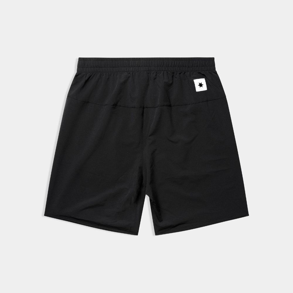 Black shorts with a small white logo on a light gray background