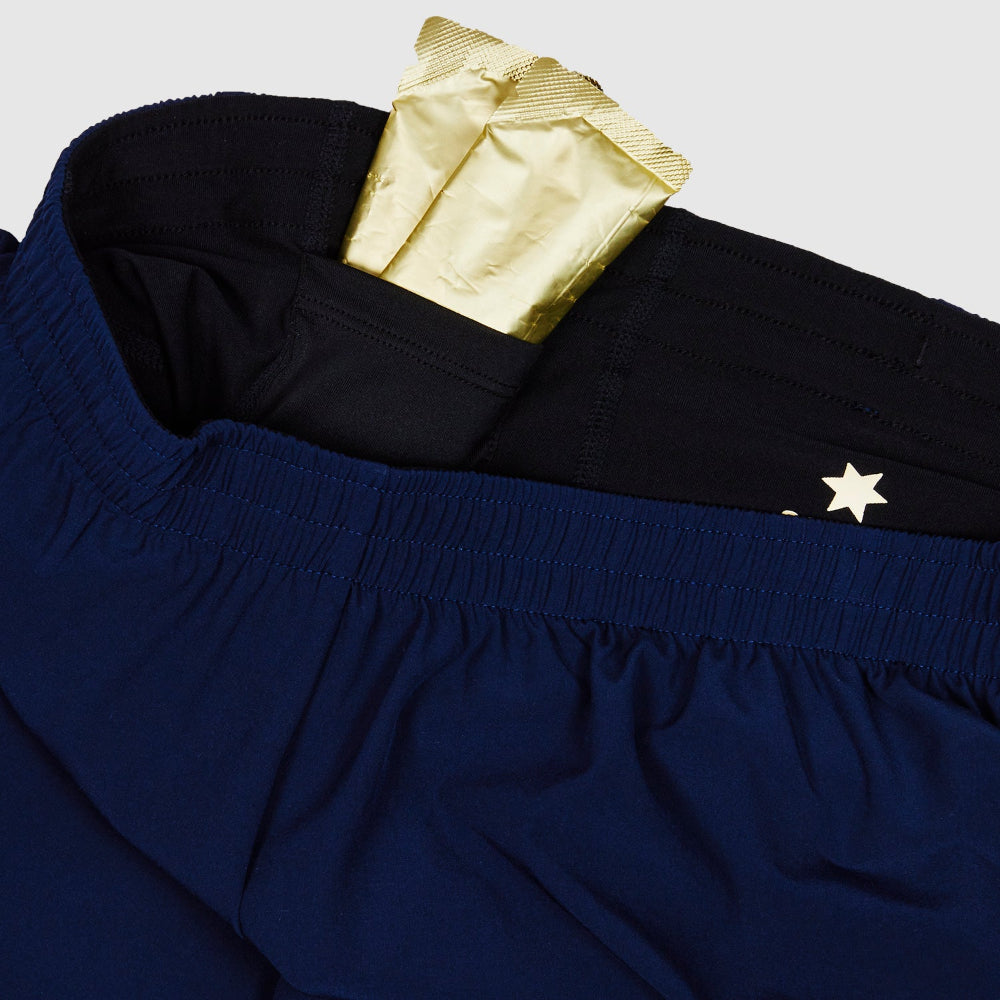 Navy blue shorts with a gold label and white star detail on a light gray background