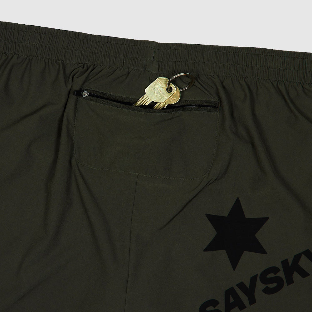 Black shorts with a gold zipper pull and star logo on a light gray background