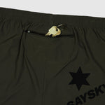 Black shorts with a gold zipper pull and star logo on a light gray background