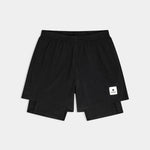 Black shorts with a small white logo on a light gray background