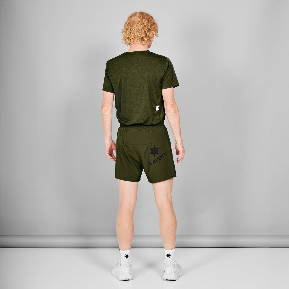 Person wearing a green t-shirt and shorts set on a gray background