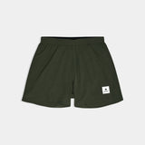 Green shorts with a brand logo on a light gray background