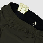 Black pants with a gold patch and Savsky logo on a light gray background