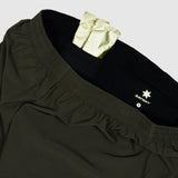 Black pants with a gold patch and Savsky logo on a light gray background