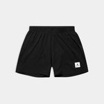 Black shorts with a brand logo on a light gray background