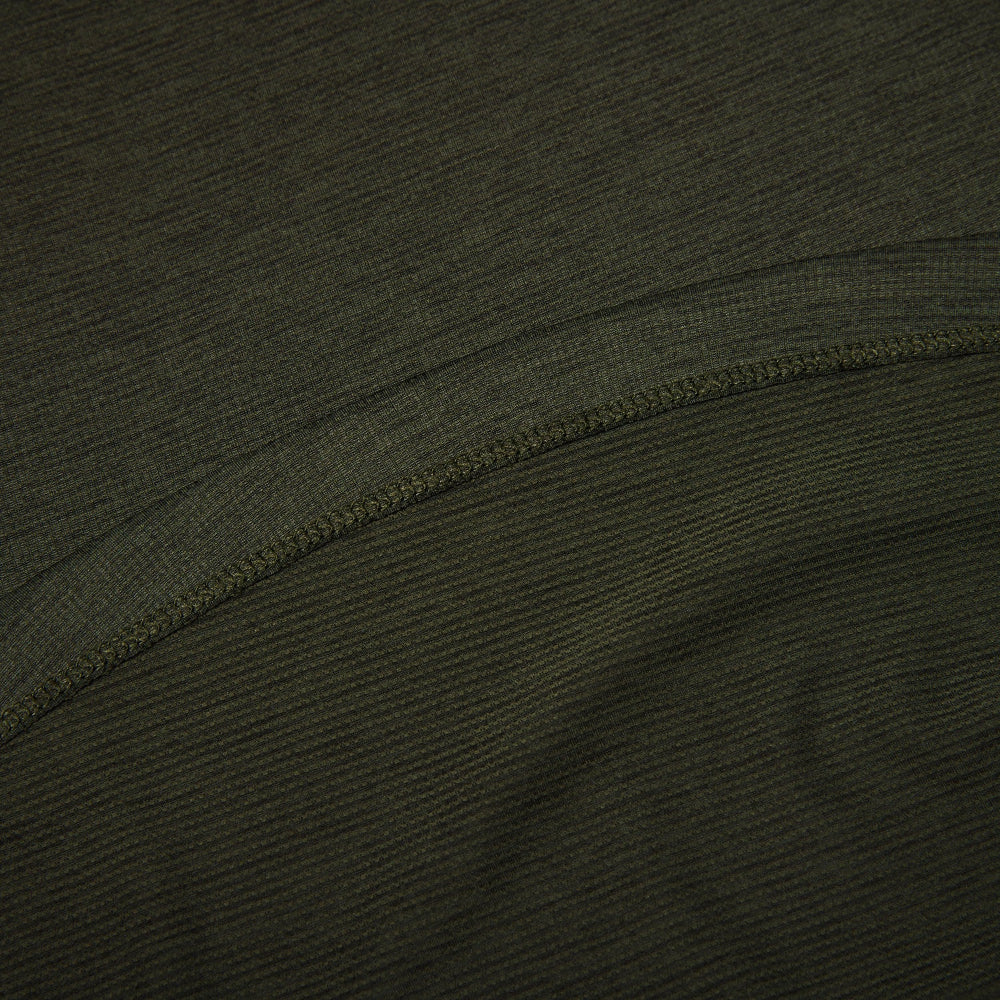 Close-up of dark green fabric with a visible seam