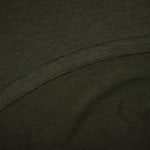 Close-up of dark green fabric with a visible seam