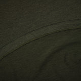 Close-up of dark green fabric with a visible seam