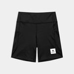 Black shorts with a visible brand label on a light gray background